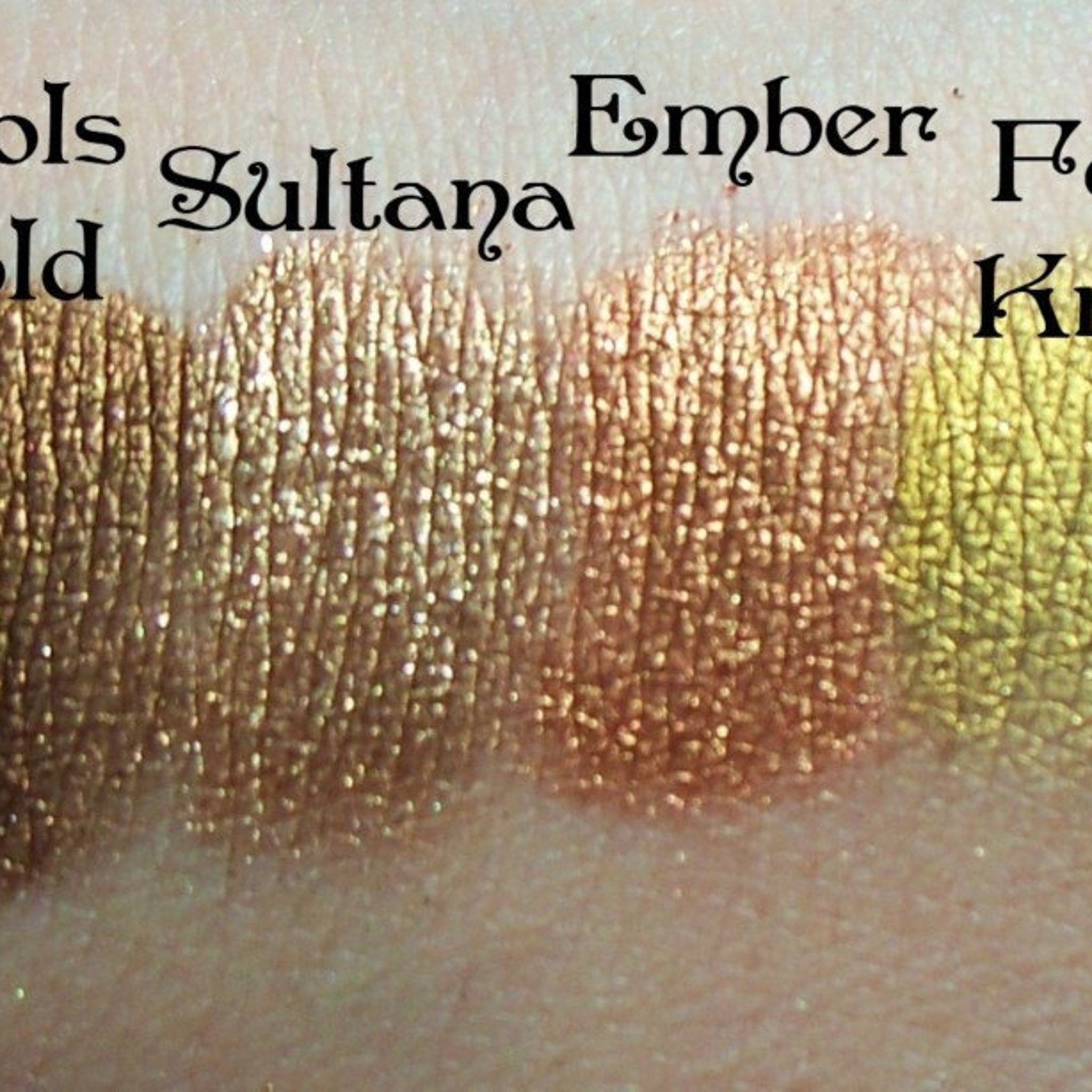 Close-up of Vintage Mineral Eyeshadow in rich dark gold with shimmering metallic finish and smooth pressed texture
