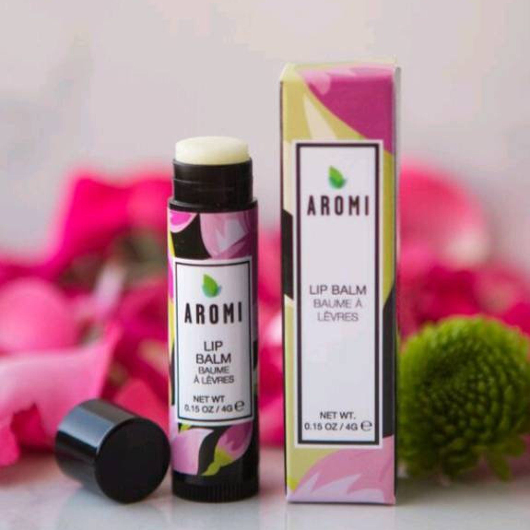 Lip balm tube with black cap, floral pattern, and Aromi brand text displayed