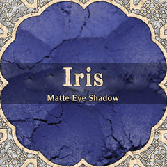 Midtoned violet vegan loose powder eyeshadow in matte finish with blue undertones, displayed in open jar.