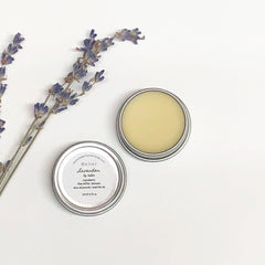 Lip balm in metal tin with lavender sprigs, Belier Lavender text visible, on white background