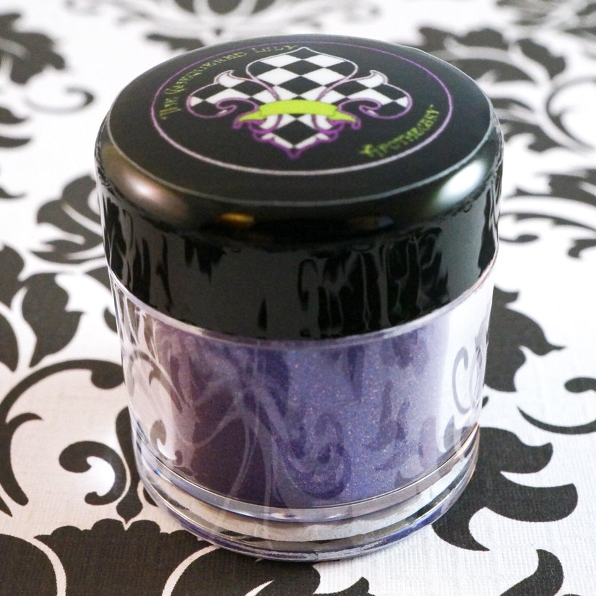 Close-up of African Violet loose pigment shimmering with metallic indigo and shifting purple glitter particles