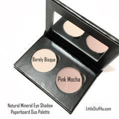 Close-up of two pink bisque eyeshadow pans in a matte paperboard palette with subtle shimmer particles
