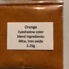 Side view of mineral eyeshadow palette showing soft matte pink and beige shades in compact case