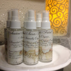 Facial mist bottles with white labels, white spray tops, and floral pattern, "Ancient Gat Secrets" text
