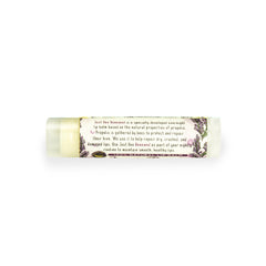 Lip balm tube with clear plastic, floral pattern, and Just Bee Renewed text