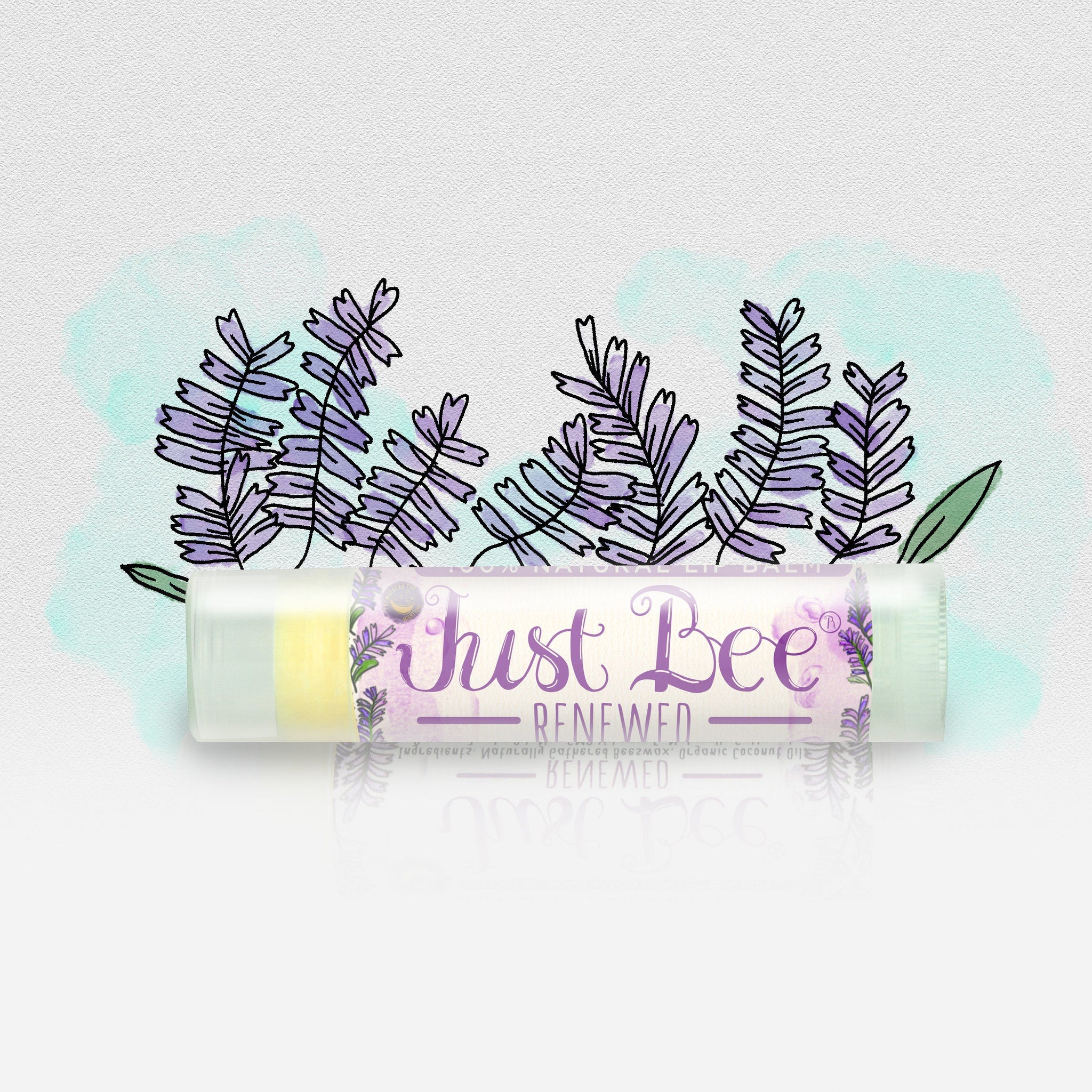 Lip balm tube with clear plastic, yellow balm, and Just Bee Renewed text