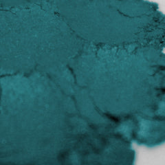 Teal powder with textured surface and light highlights