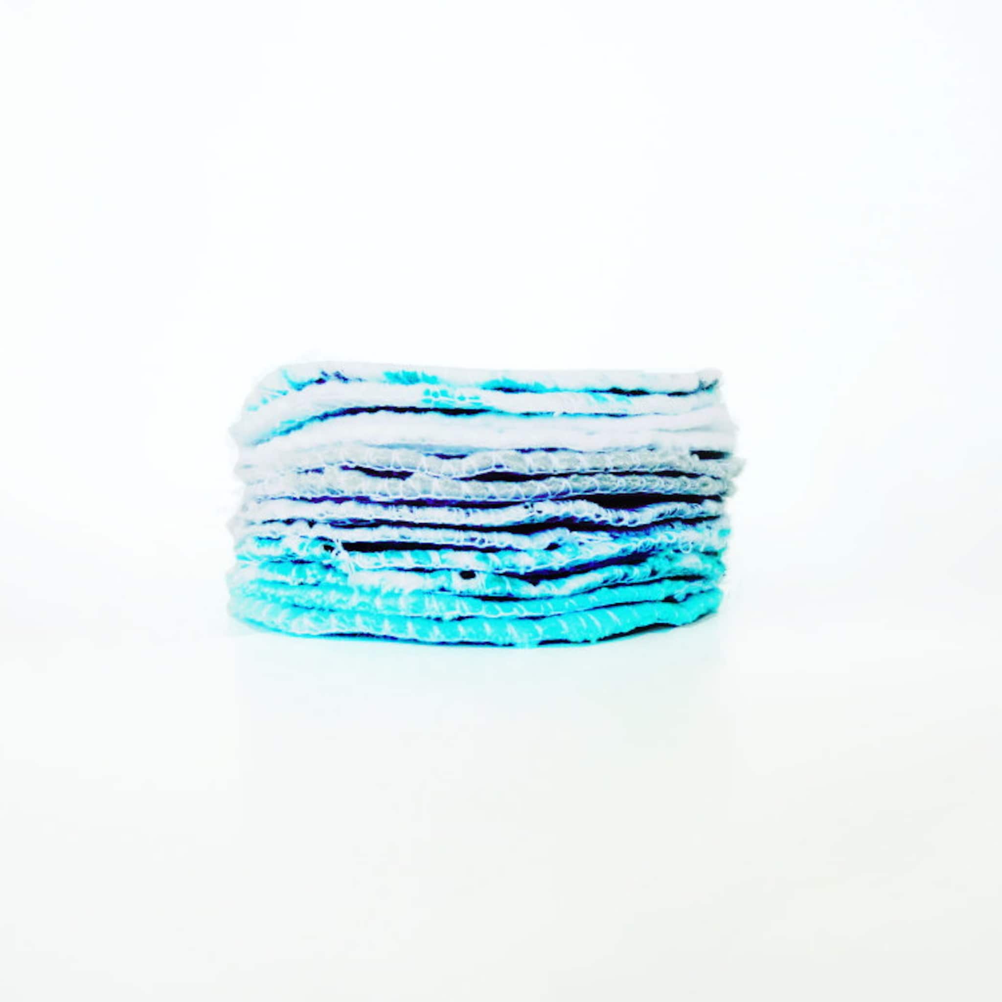 Blue and white stacked fabric with layered texture and soft edges, on white background