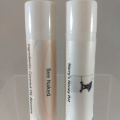 Lip balm tubes, white and peach, with printed text and logos, Bee Naked and Harry's Honey Pot labels