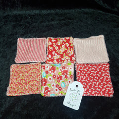 Reusable facial rounds, assorted floral patterns, red and pink fabrics, Anita Rose Designs tag