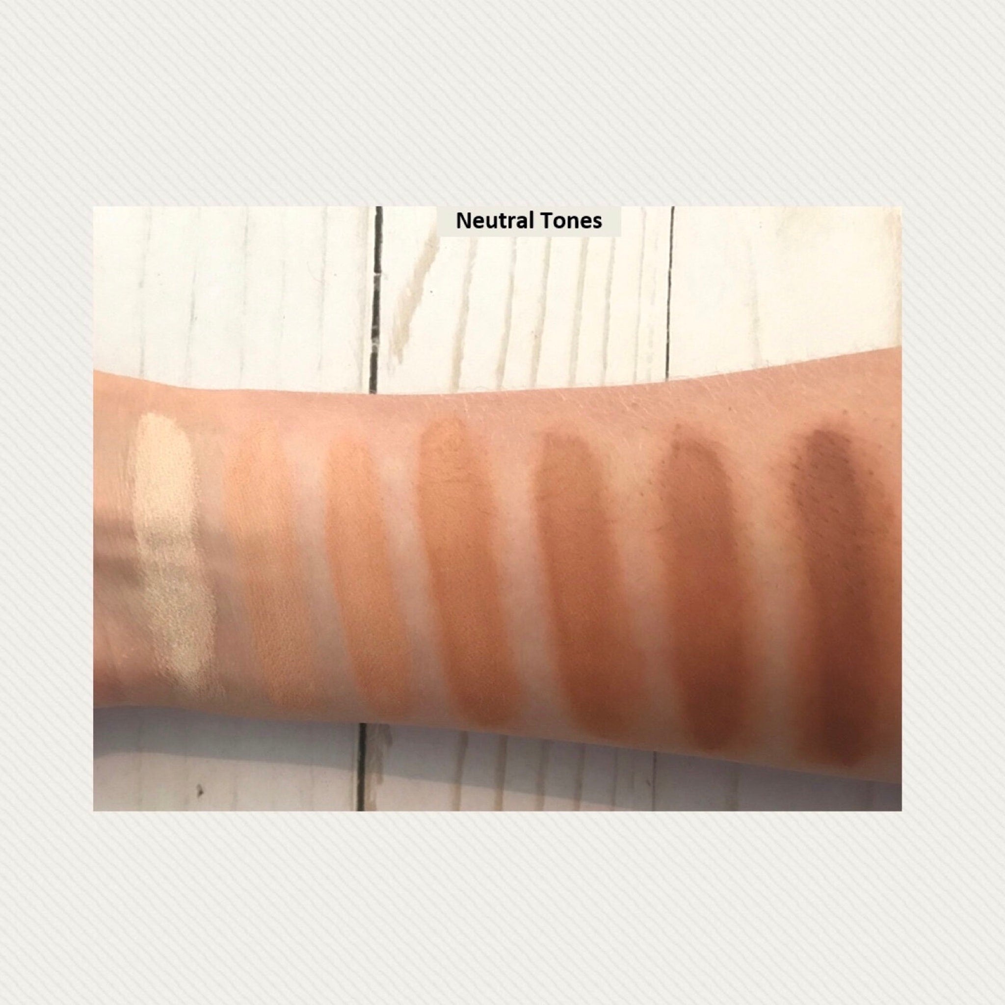 Foundation swatches in various neutral shades on arm for color comparison