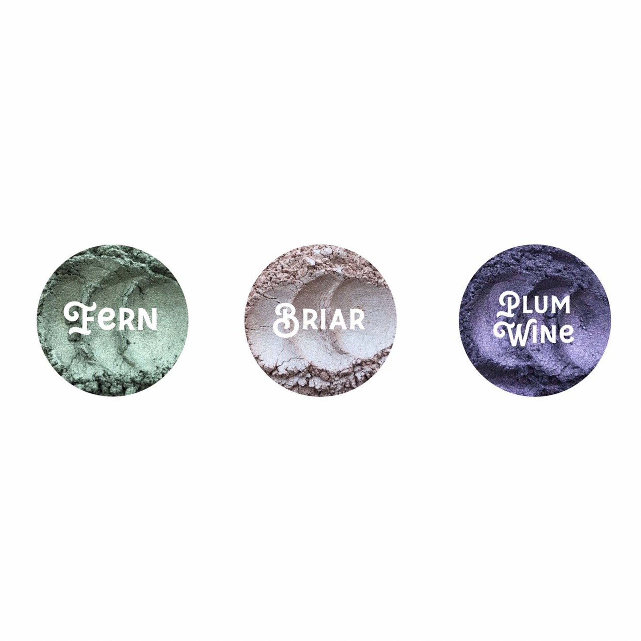 Close-up of Planet Wise vegan loose mineral eye shadow in glass jar with black screw-top lid and silver label