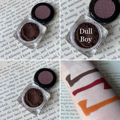 Single pan of bold dark red-brown matte eyeshadow with smooth velvety finish in black compact