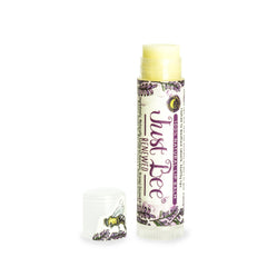 Lip balm tube with yellow balm, white cap, and Just Bee branding with purple floral pattern.
