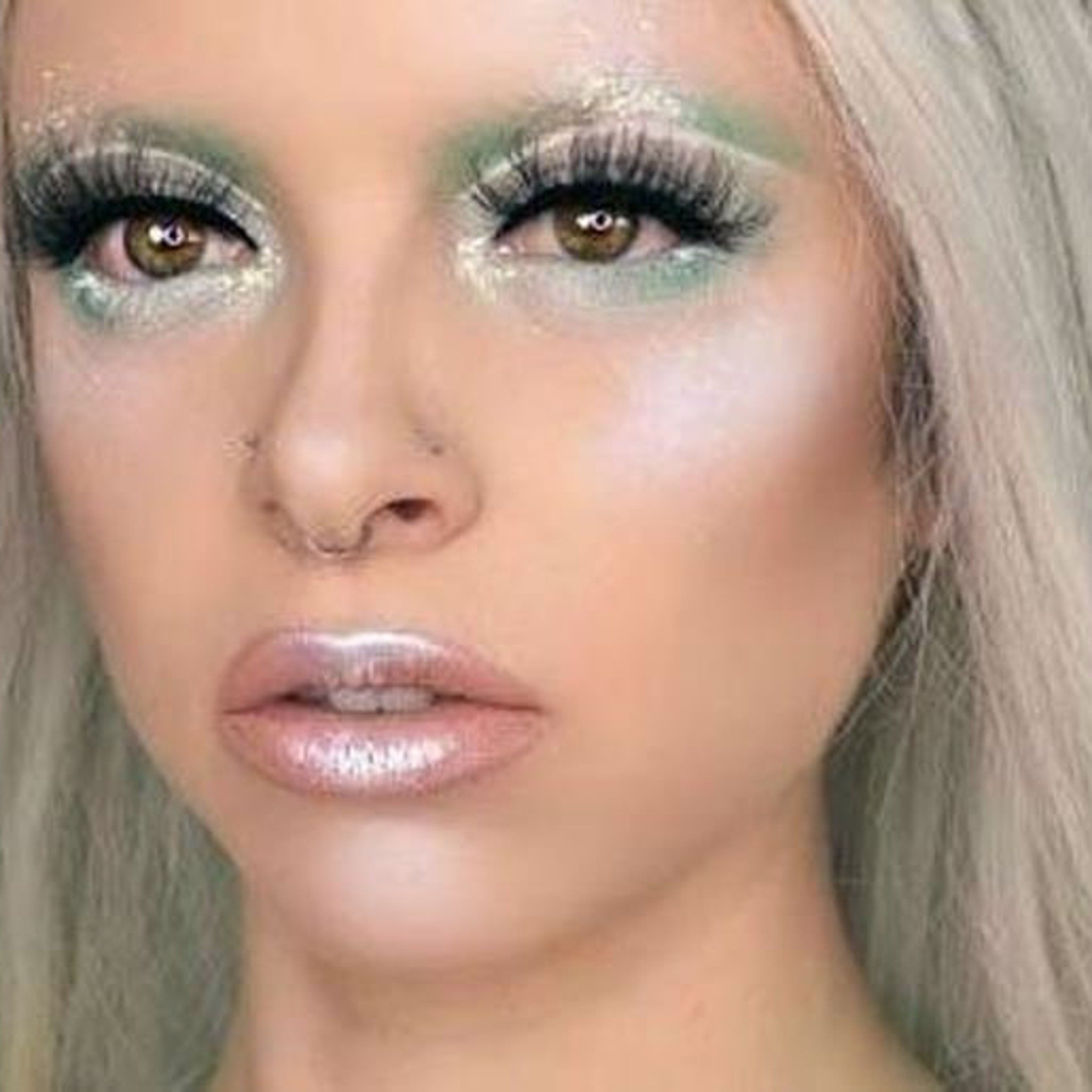 Vegan Halloween eye shadow palette open to reveal holographic white, teal, and peach pink sparkly shades