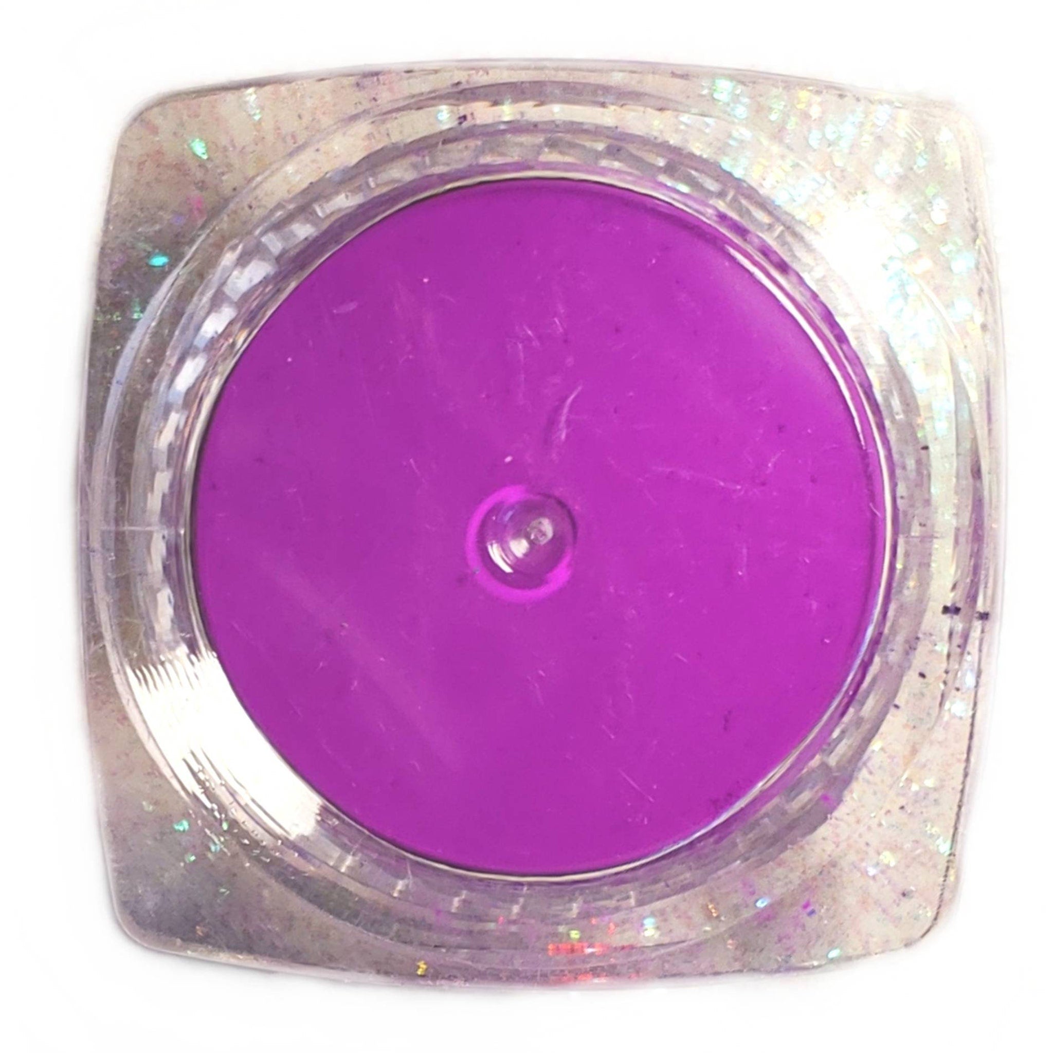 Close-up of vibrant neon purple UV eyeshadow powder with intense glow pigment for festival makeup looks