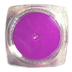 Close-up of vibrant neon purple UV eyeshadow powder with intense glow pigment for festival makeup looks