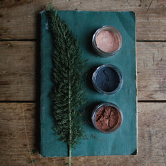 Planet Wise vegan loose mineral eye shadow in glass jar with sifter, showcasing natural powder texture and earthy tones.