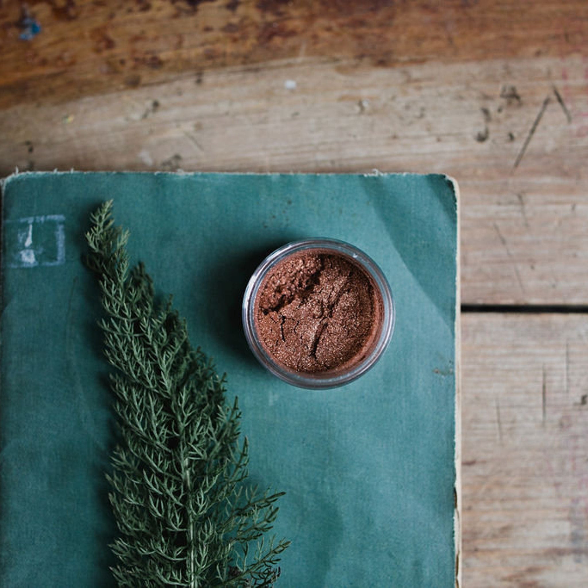 Close-up of loose mineral eyeshadow powder in a vibrant shade with natural shimmer particles