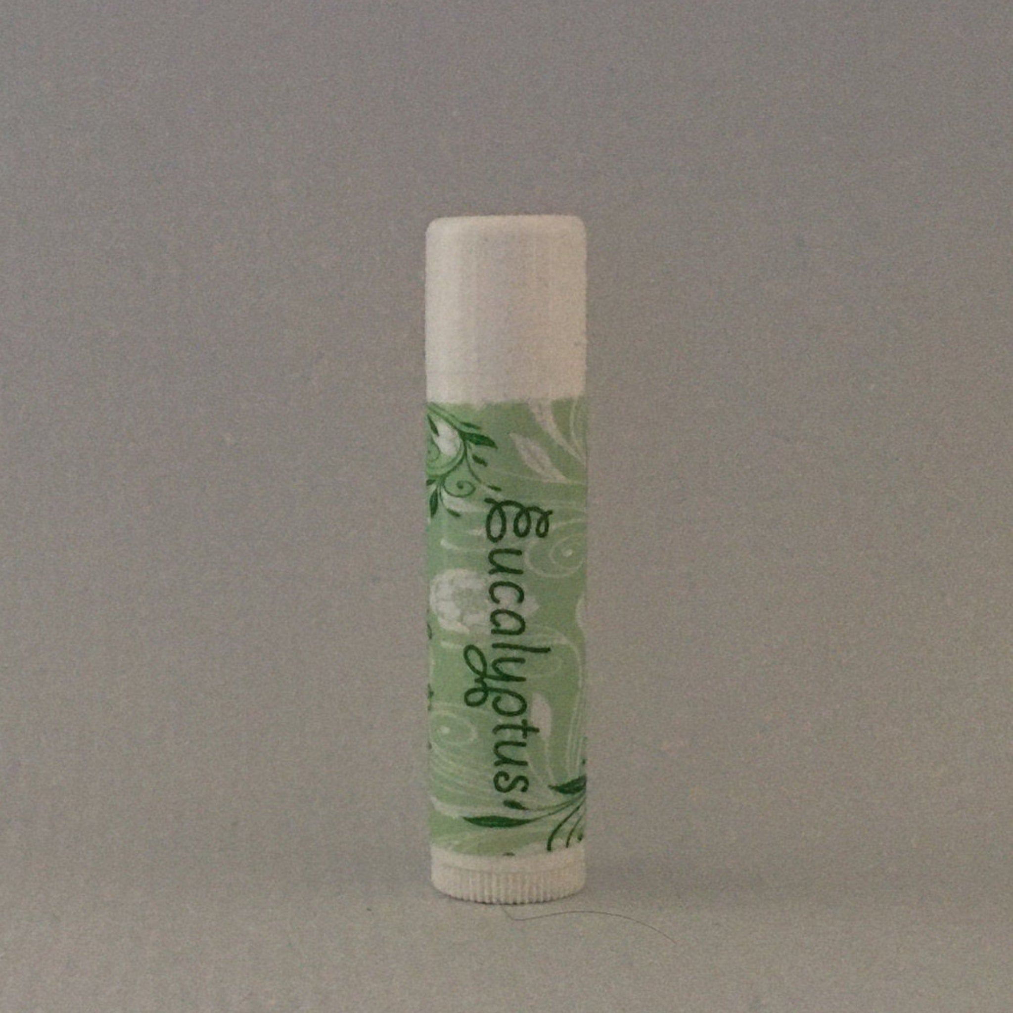 Lip balm tube with white top, green patterned label, and "Eucalyptus" text on it.