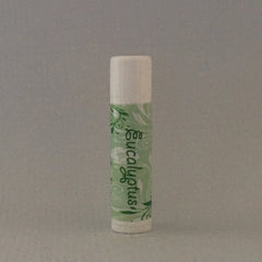 Lip balm tube with white top, green patterned label, and "Eucalyptus" text on it.