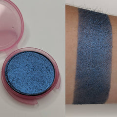 Close-up of vegan sapphire blue pressed eyeshadow in compact with smooth shimmer finish