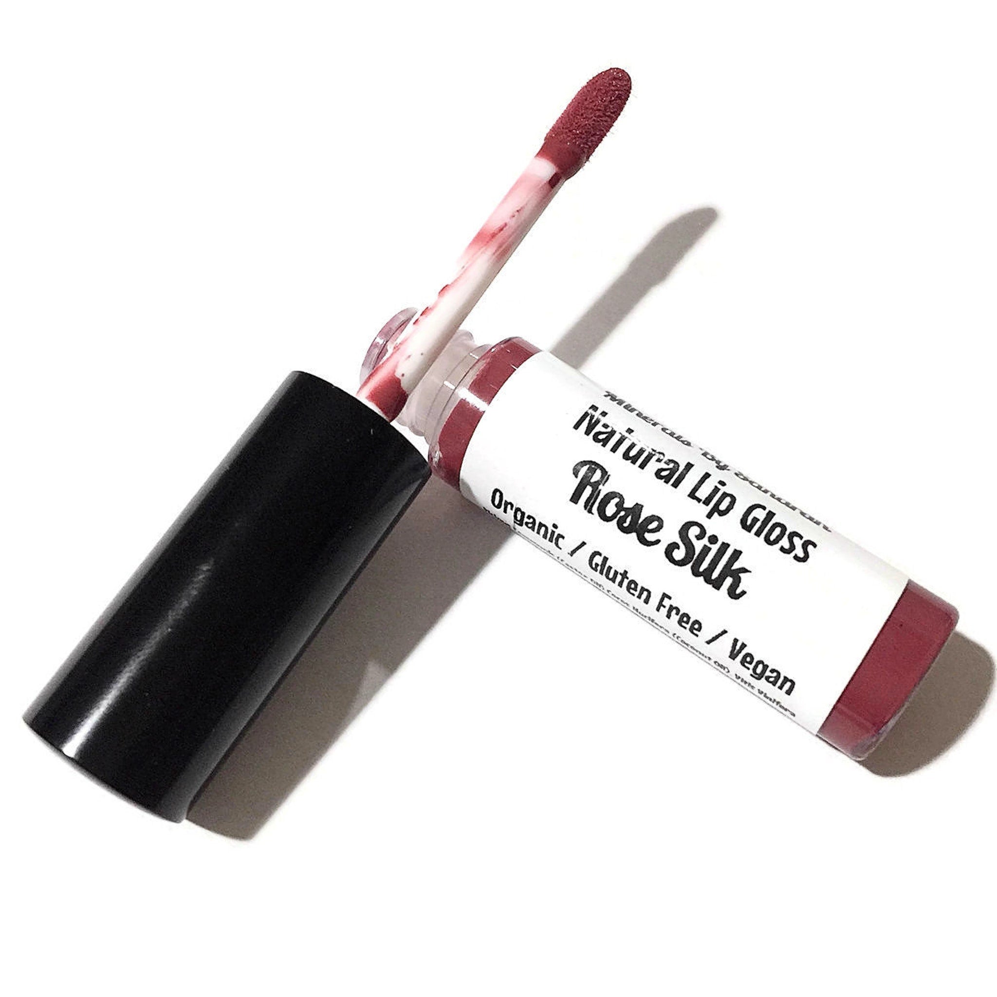 Lip gloss with red color and black cap, ROSE SILK brand visible