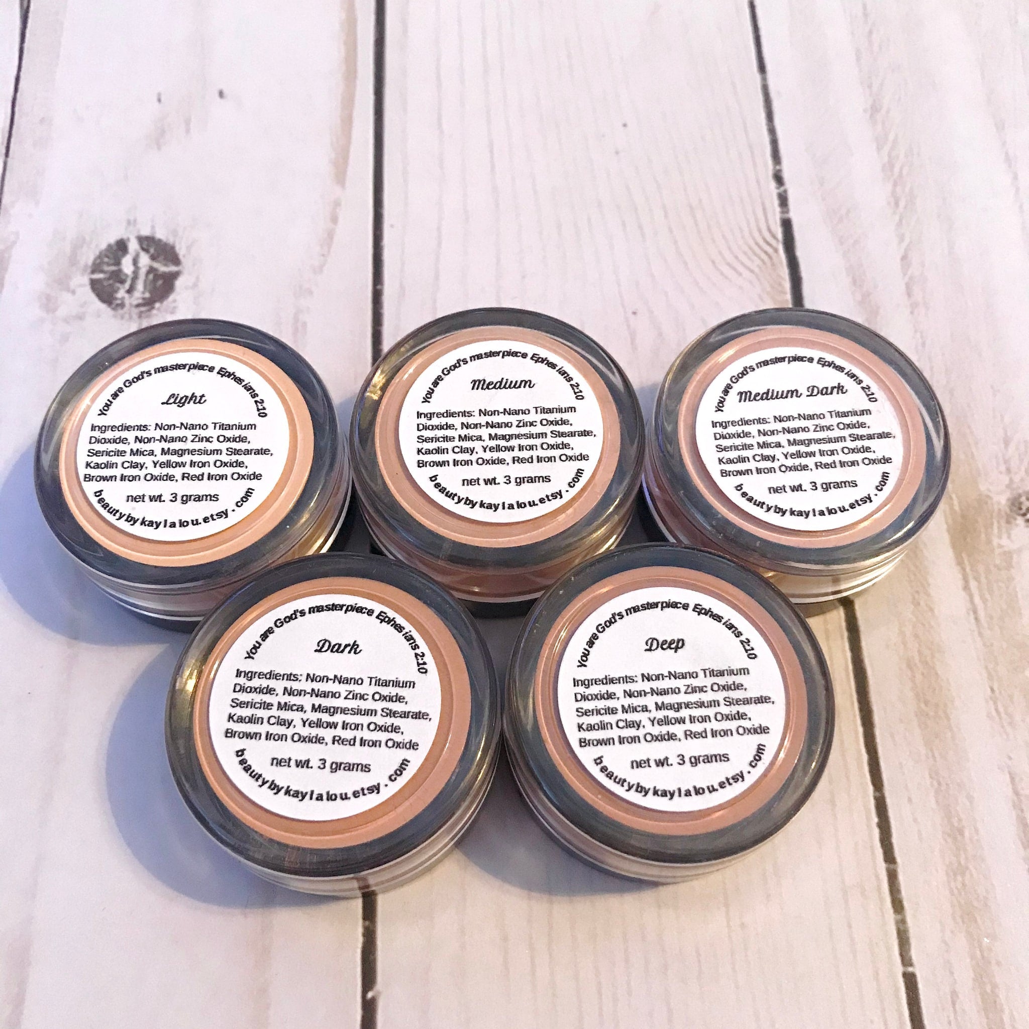 Mineral powder makeup in various shades, labeled "Light" to "Deep", from Beauty by Kayla Lou