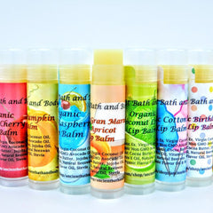 Lip balm tubes in various colors, with Ancient Bath and Body labels and ingredients listed on tubes
