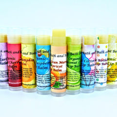 Lip balm tubes with colorful labels, Ancient Bath and Body branding, and various flavors shown