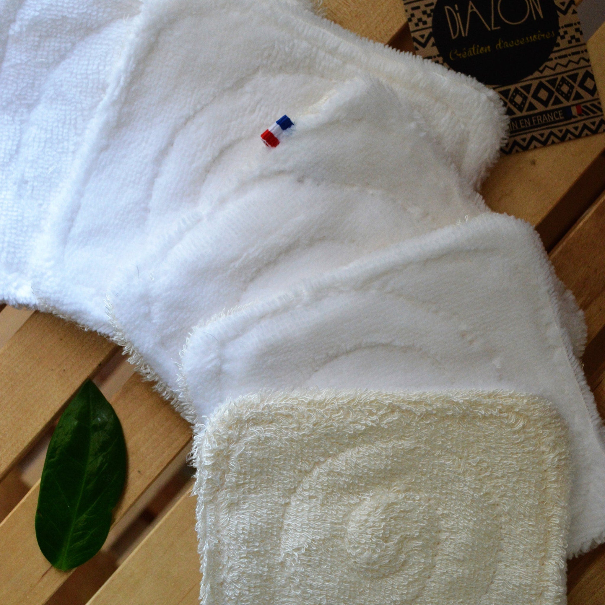 Close-up of textured bamboo makeup wipe showing double-sided reusable fibers with eco-friendly certification seal