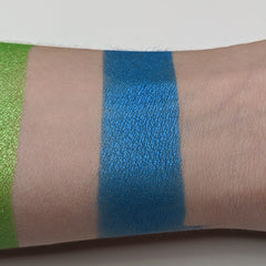 Side angle of vegan teal blue pressed eyeshadow in compact, showcasing smooth matte finish and rich pigment saturation.