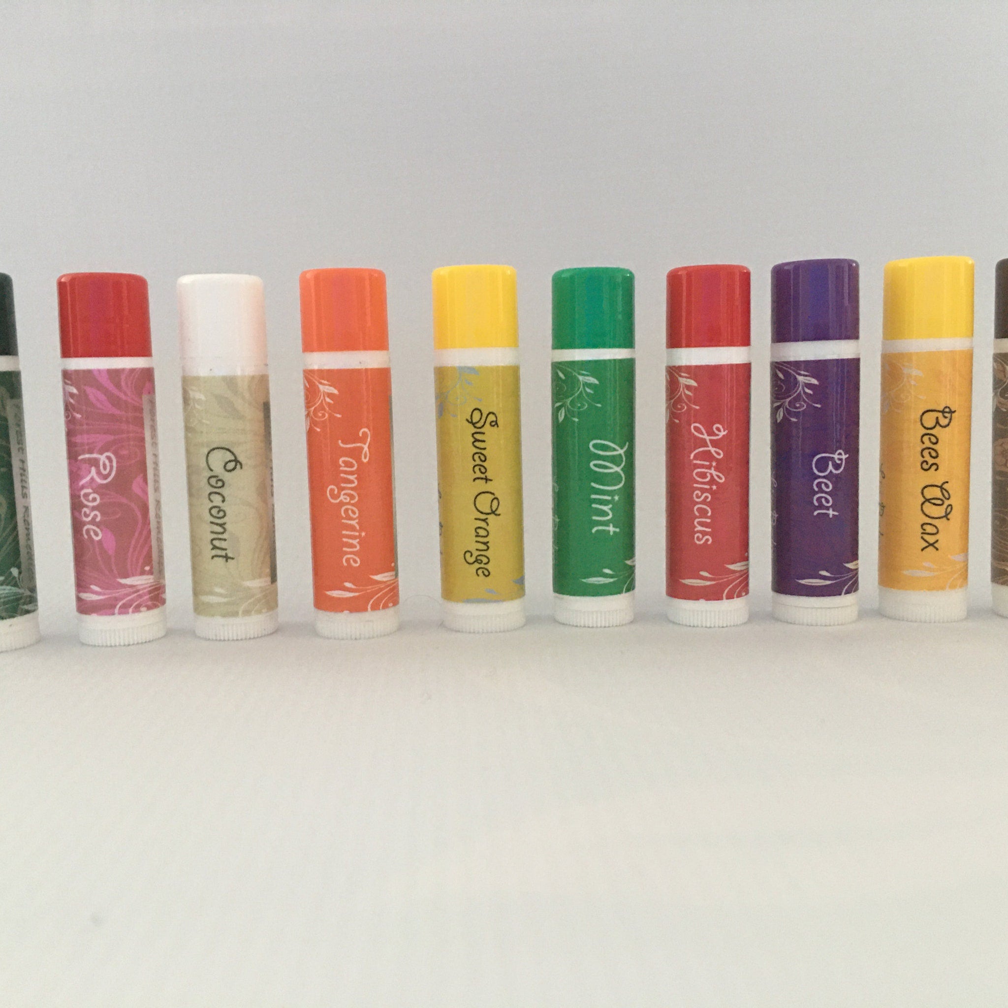 Lip balm tubes in various colors with flavor names printed on the labels