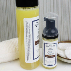 Face cleanser bottles with yellow liquid, black caps, and white labels with "deep well botanicals" text