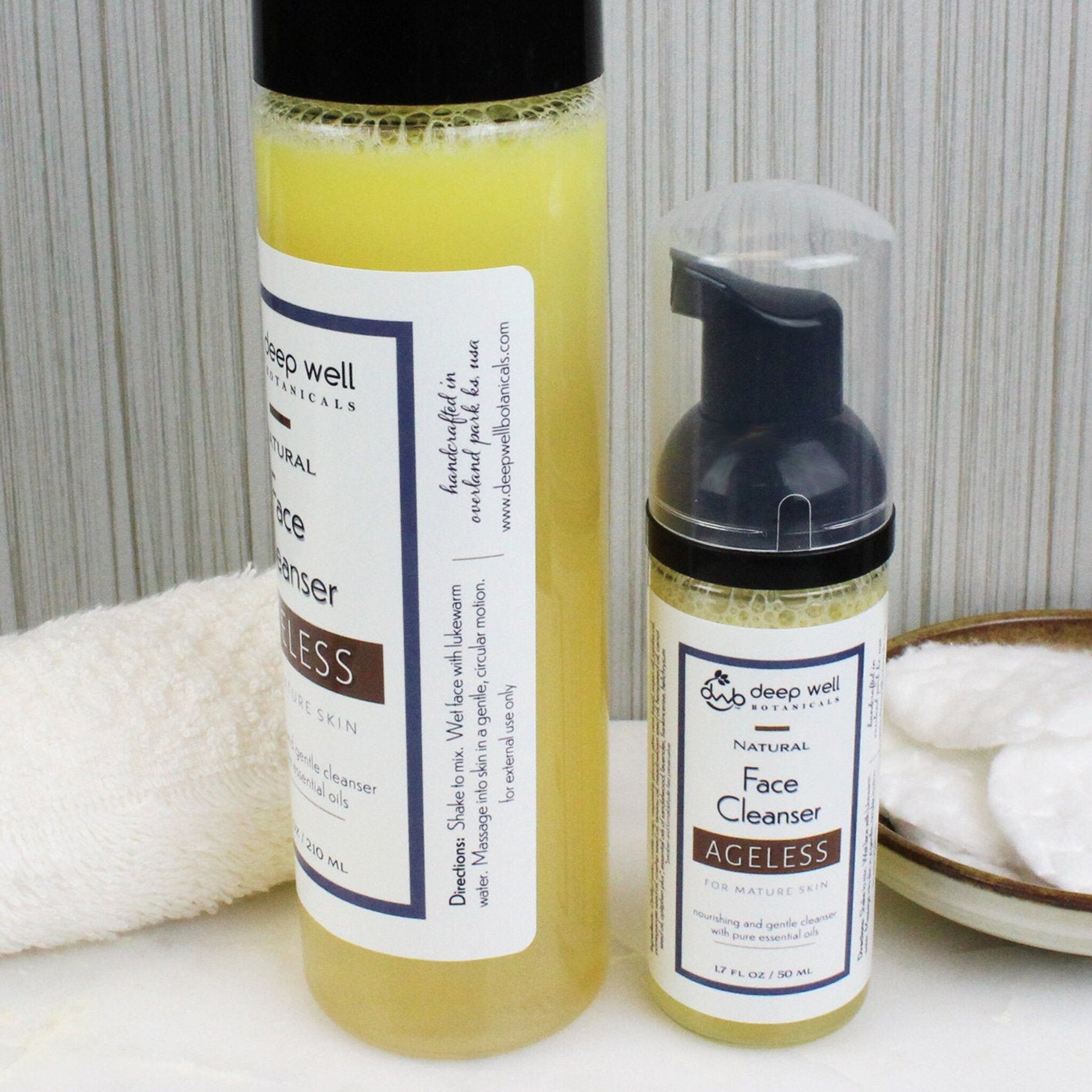 Face cleanser bottles with yellow liquid, black cap, and Deep Well Botanicals label