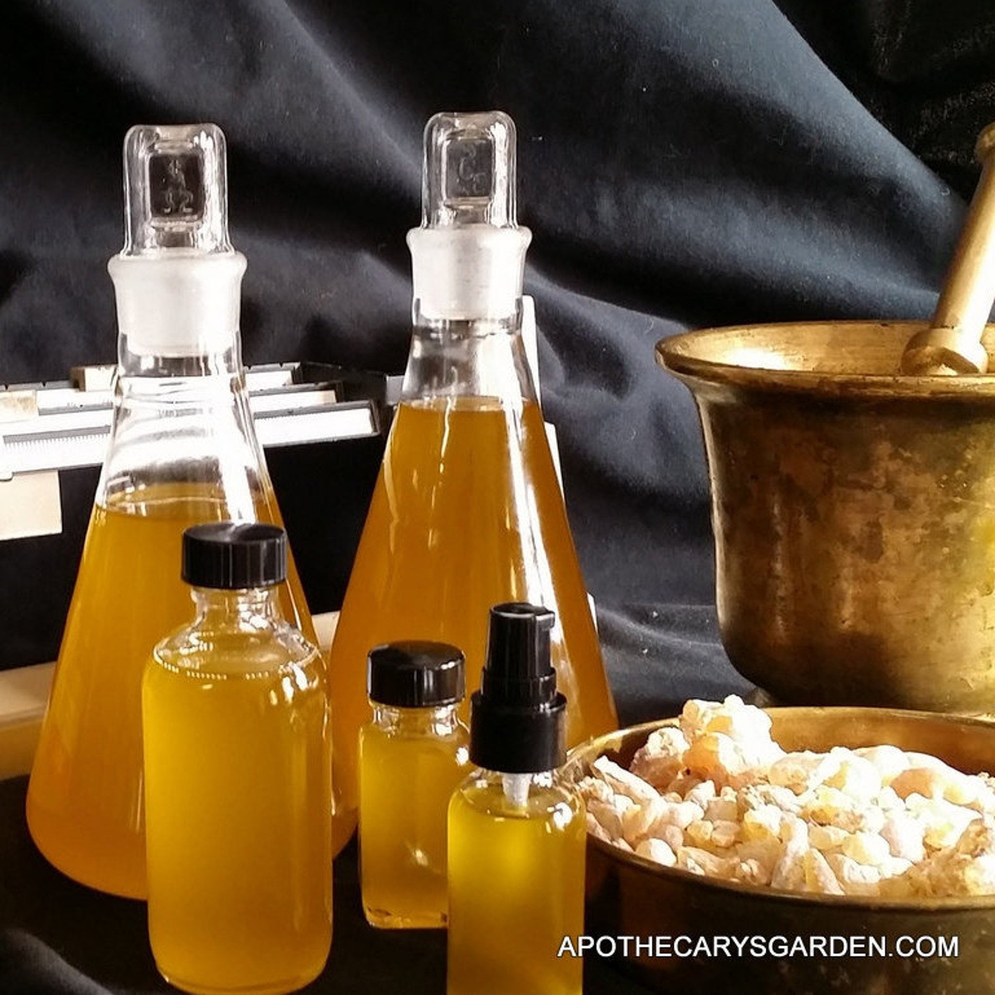 Skin care extract in clear glass bottles with amber liquid, and Apothecarys Garden text