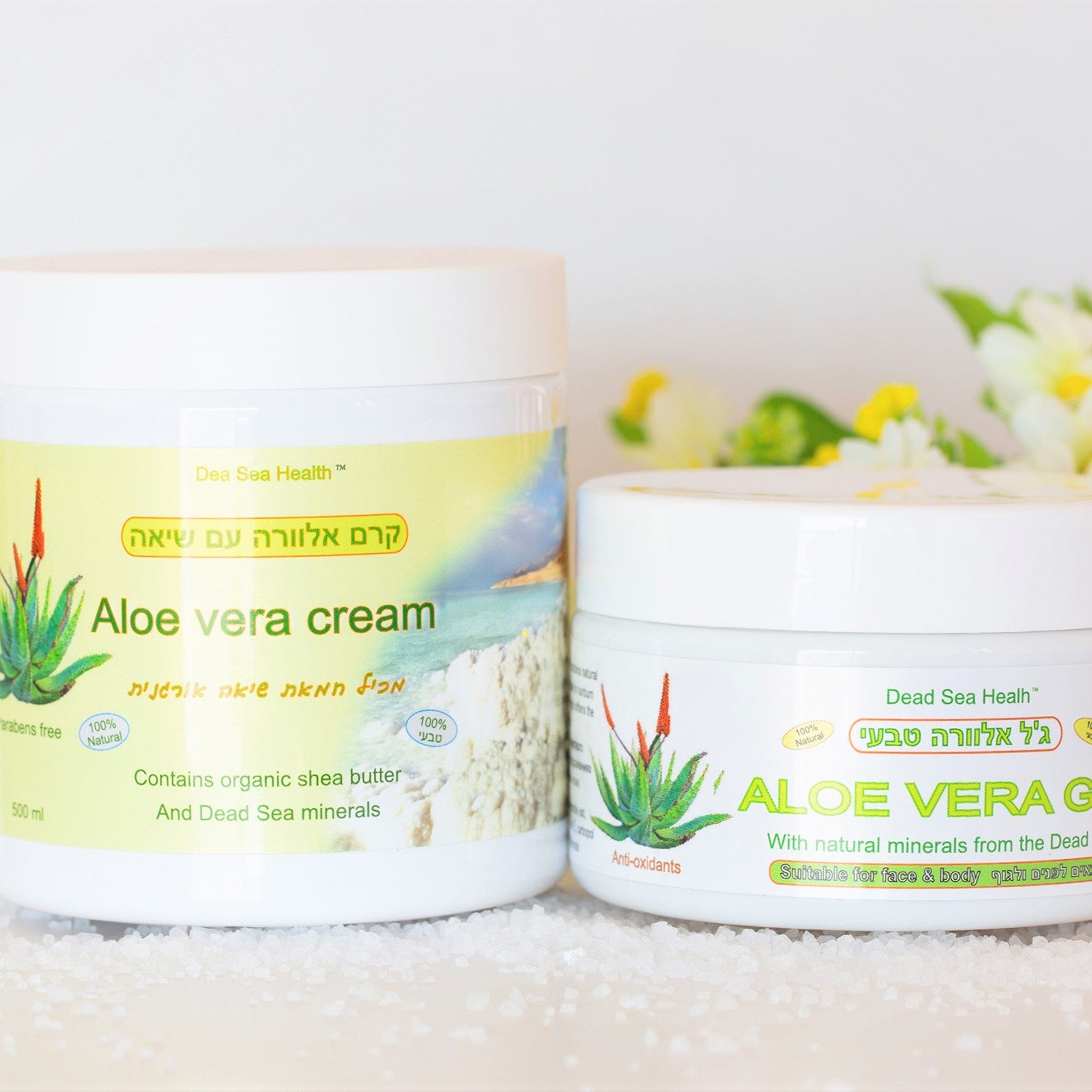 Aloe vera cream jars, white plastic containers with green and yellow labels, Dead Sea Health brand visible