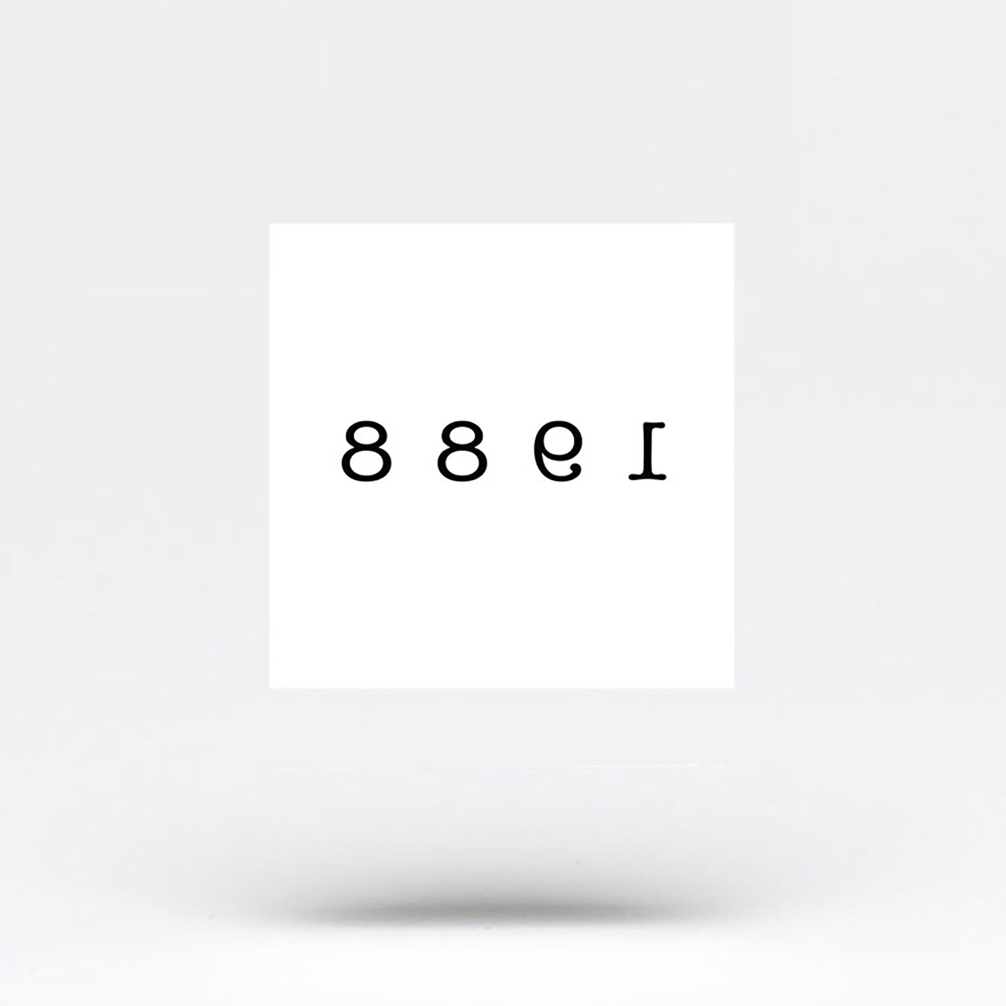 Close-up of delicate 1988 birth year temporary tattoo applied on wrist with natural skin texture visible