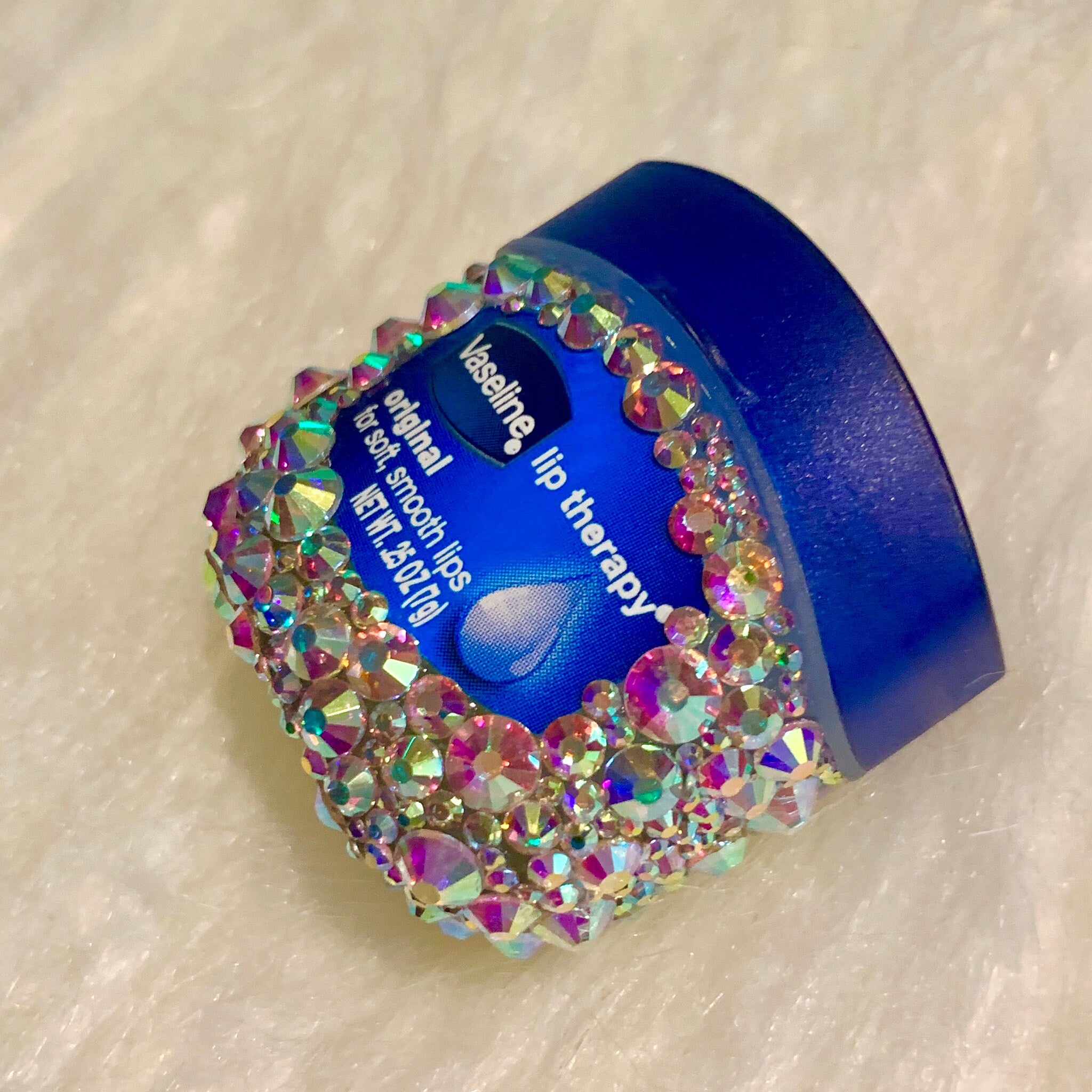 Lip therapy jar, blue container with iridescent rhinestone embellishments, Vaseline brand visible