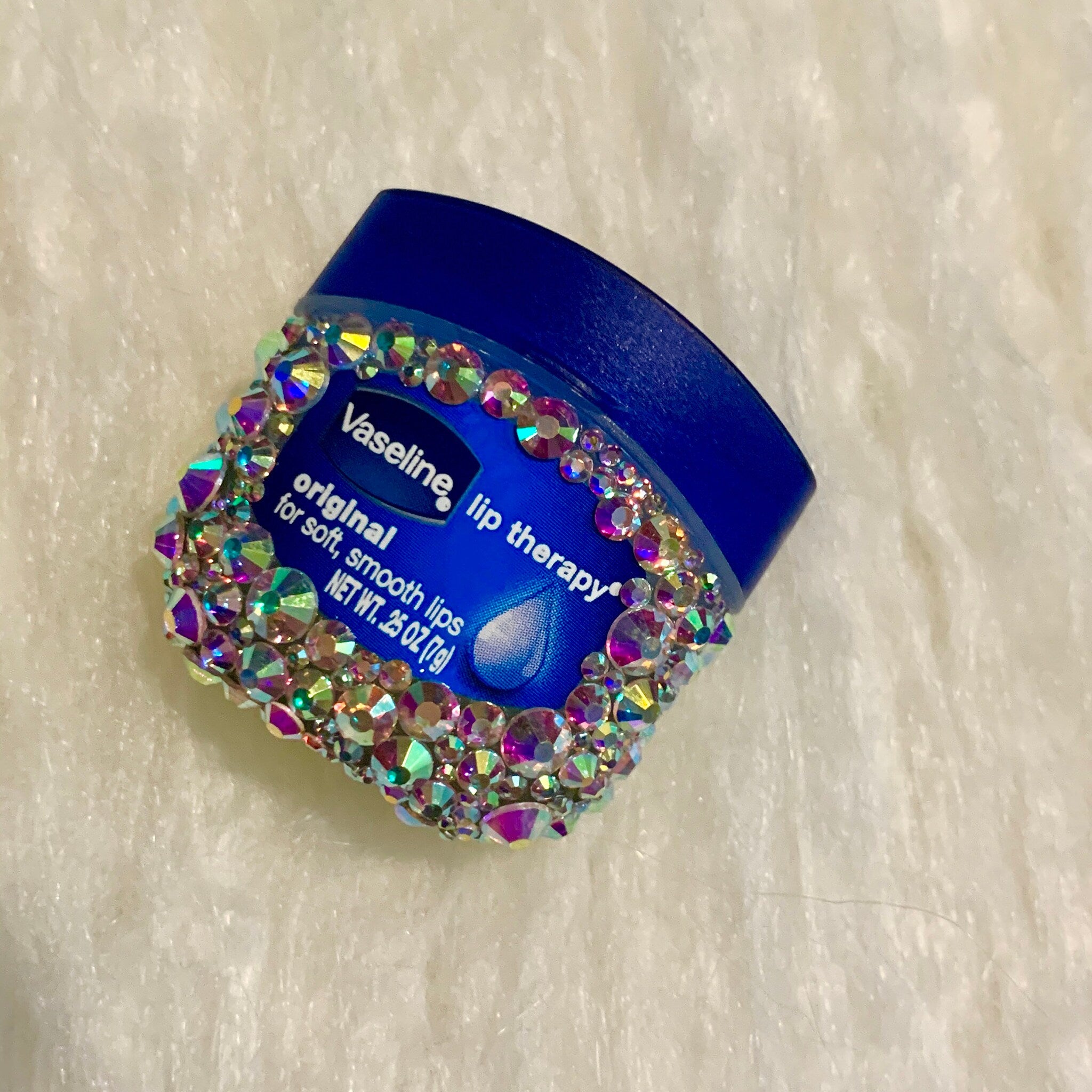 Lip therapy jar, blue container with rhinestones, Vaseline lip therapy brand name visible