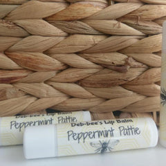 Lip balm tubes, white with yellow pattern, Deb*bee's Peppermint Pattie text, near woven basket