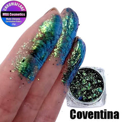 Close-up of multichrome eyeshadow flakes shimmering with shifting iridescent hues in a textured finish
