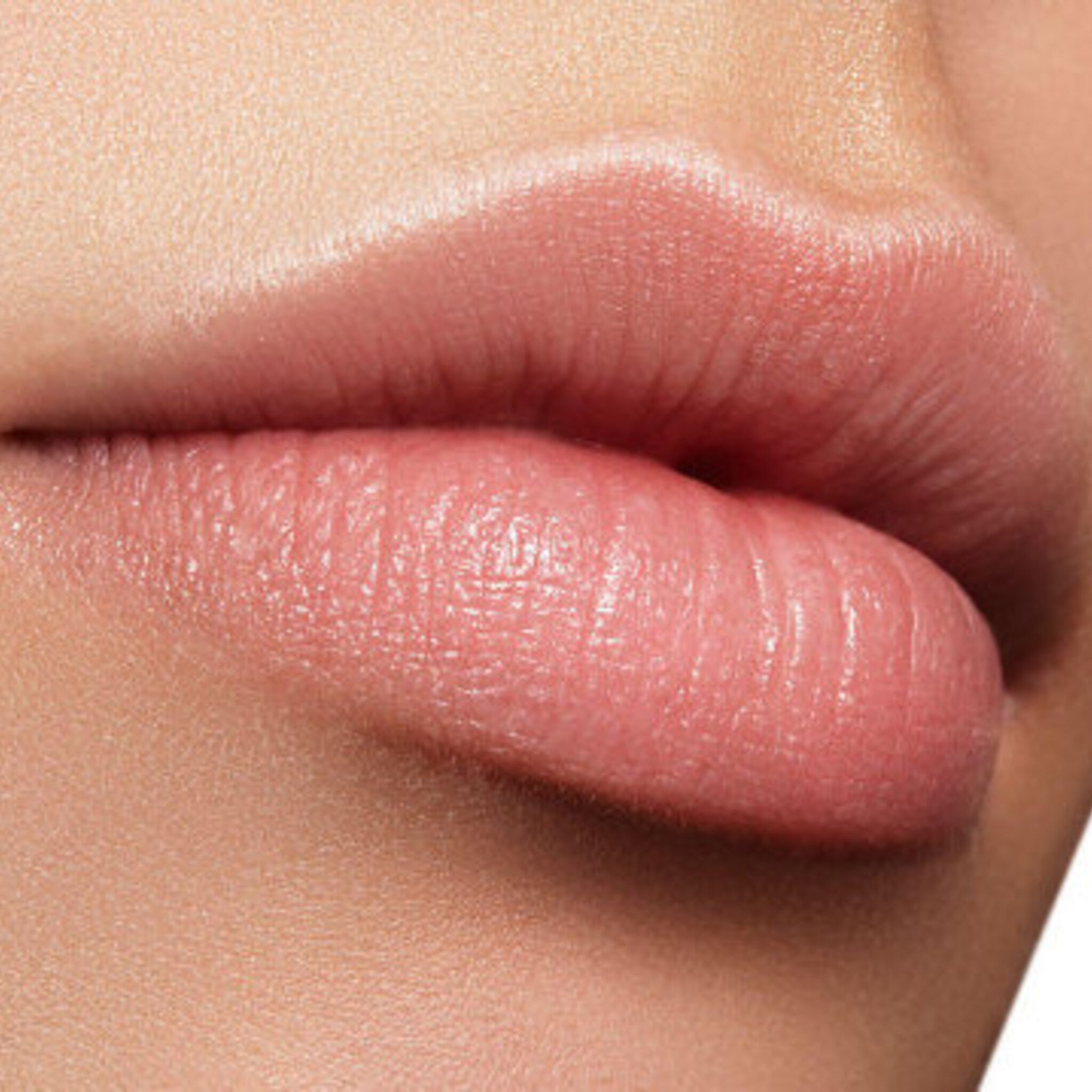 Lip balm application, close up of pink lips with smooth texture and subtle shine
