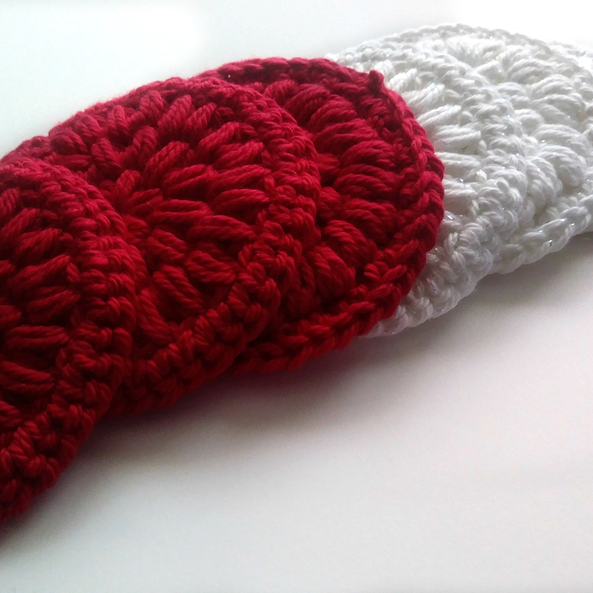 Crocheted coasters, red and white yarn, textured pattern, round shape