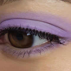 Close-up of matte lavender eyeshadow pan showing smooth, velvety powder texture in soft purple hue