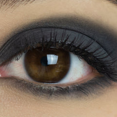 Extreme close-up of matte black vegan eyeshadow pan showing rich pigment and smooth texture
