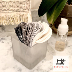 Reusable facial rounds in gray, white, and black, stacked in a square container, LanCraftUS logo visible