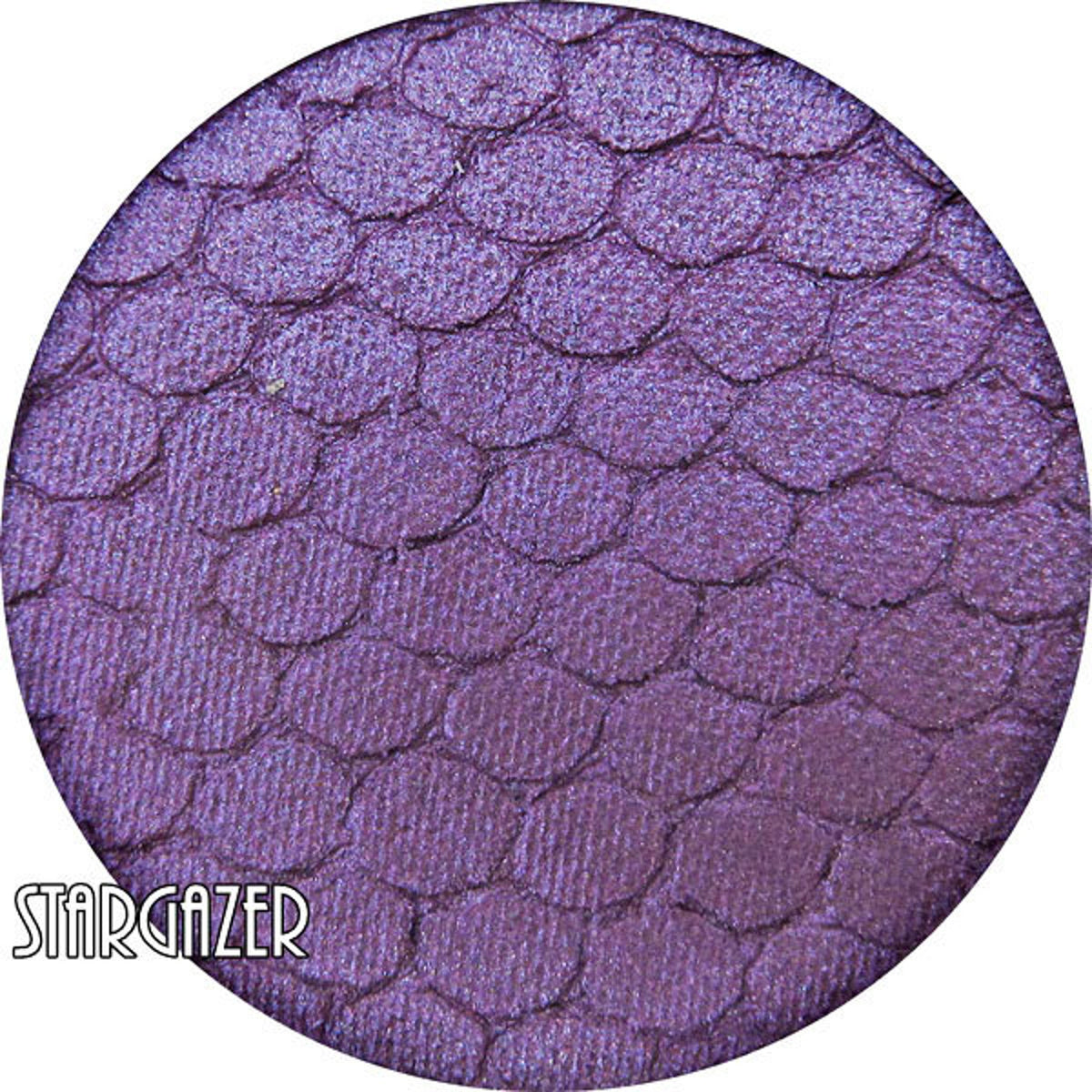 Stargazer pressed mineral eyeshadow in vibrant purple with smooth satin finish, shown in compact case