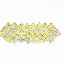 Napkins with yellow pineapple pattern on blue and purple background, folded style