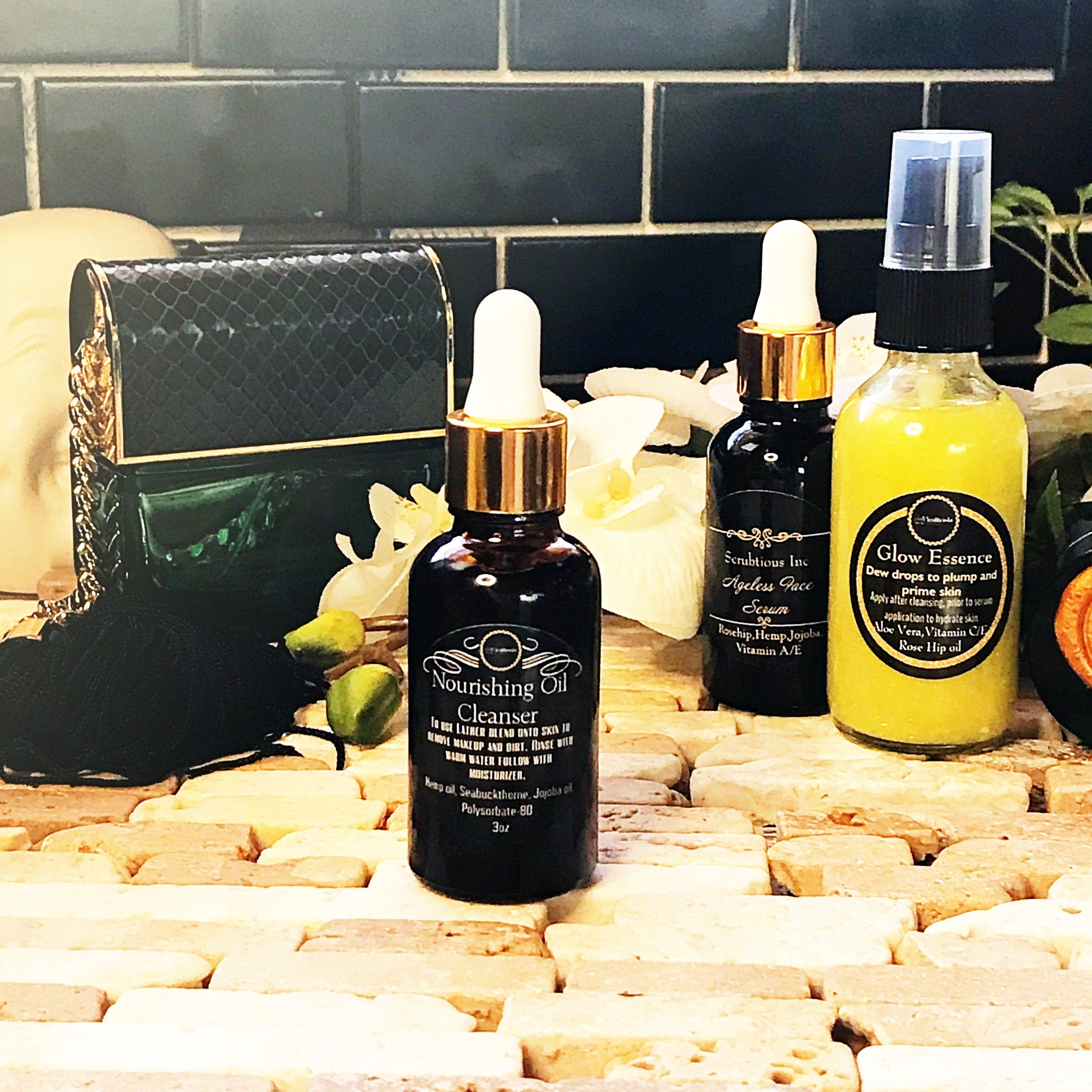 Skincare products with black and gold bottles on a brick surface, with text labels visible